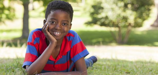 boy reading in park