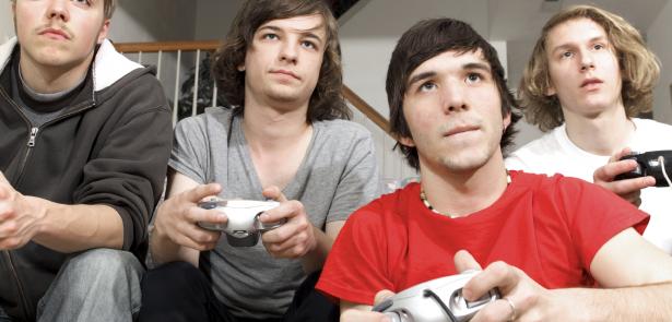 teen boys playing video games