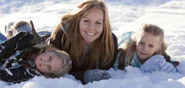 family playing in snow