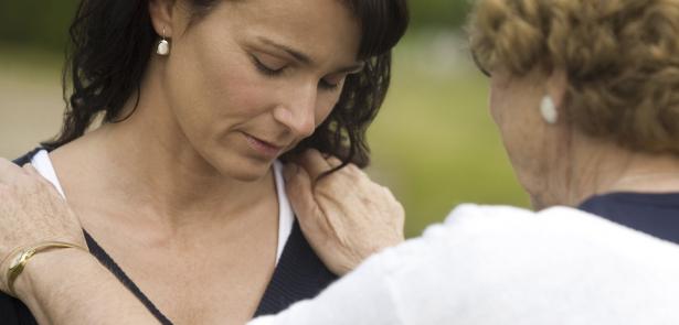 sorrowful woman being comforted