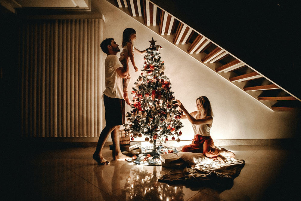 Connecting with your children at Christmas blog post - a family at Christmas decorating the tree