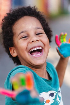 a kid with paint on his hands